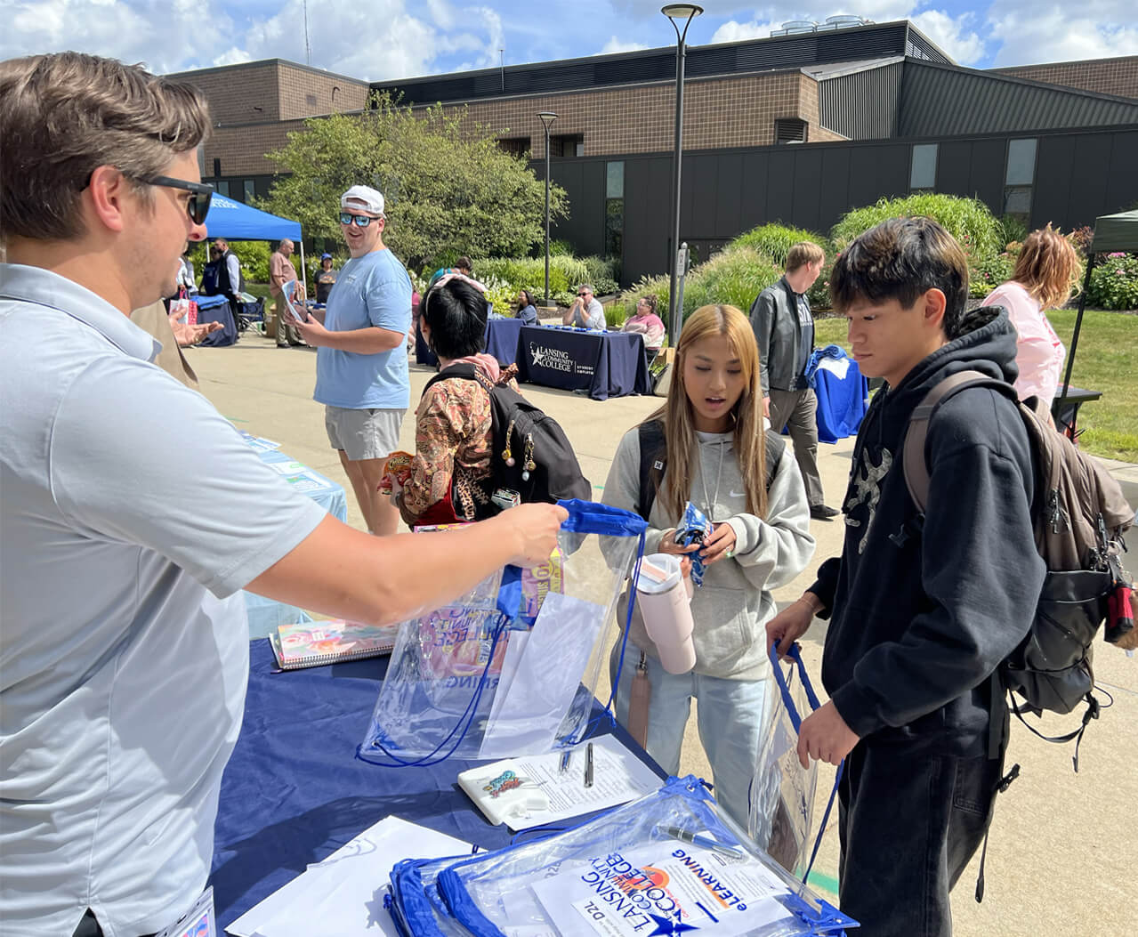Man handing out eLearning bags and flyers.